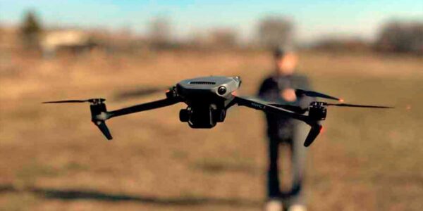 letnaya-praktika-dji-mavic-3-trenirovka Дрон DJI Mavic 3 в режиме зависания во время практического занятия. Пилот управляет дроном на открытой местности, отрабатывая навыки стабилизации и съёмки.